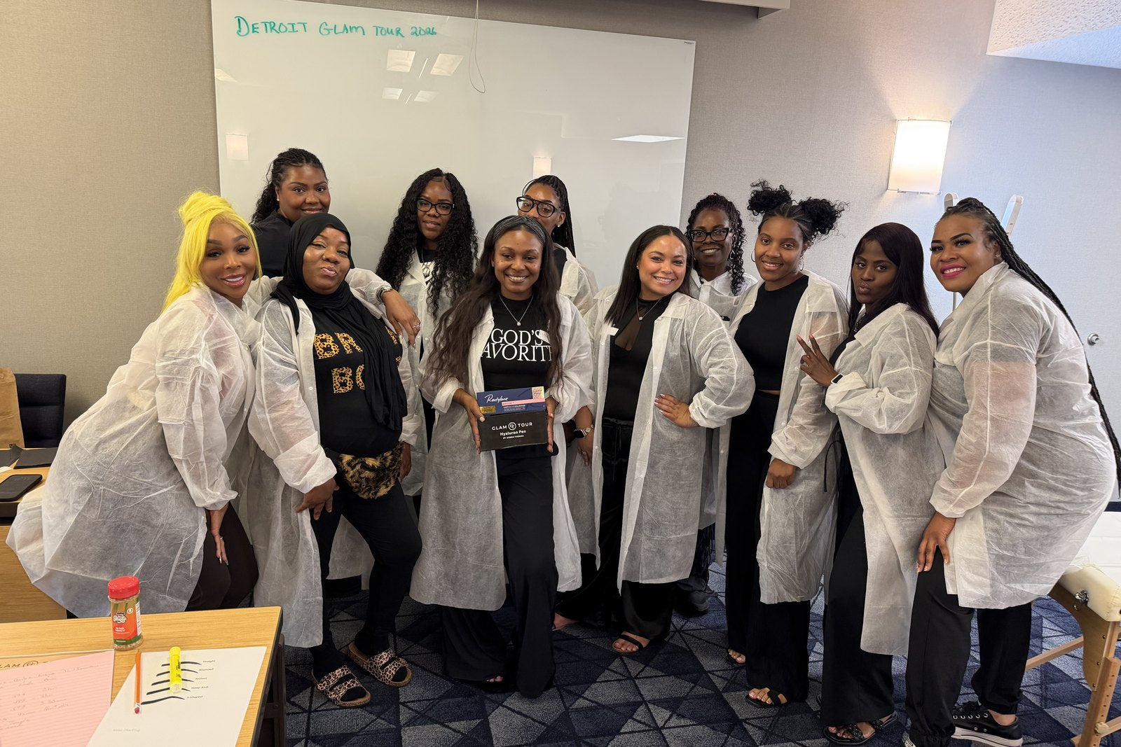 The Detroit Glam Tour class of July 2026 in Glam Tour lab coats after certification